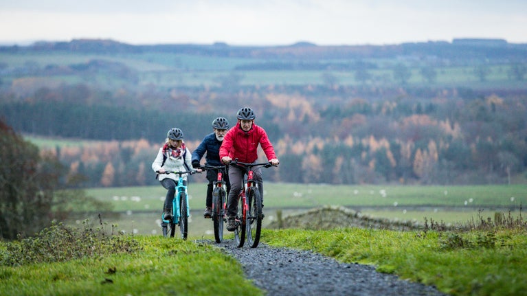 A family cycling at Wallington, Northumberland